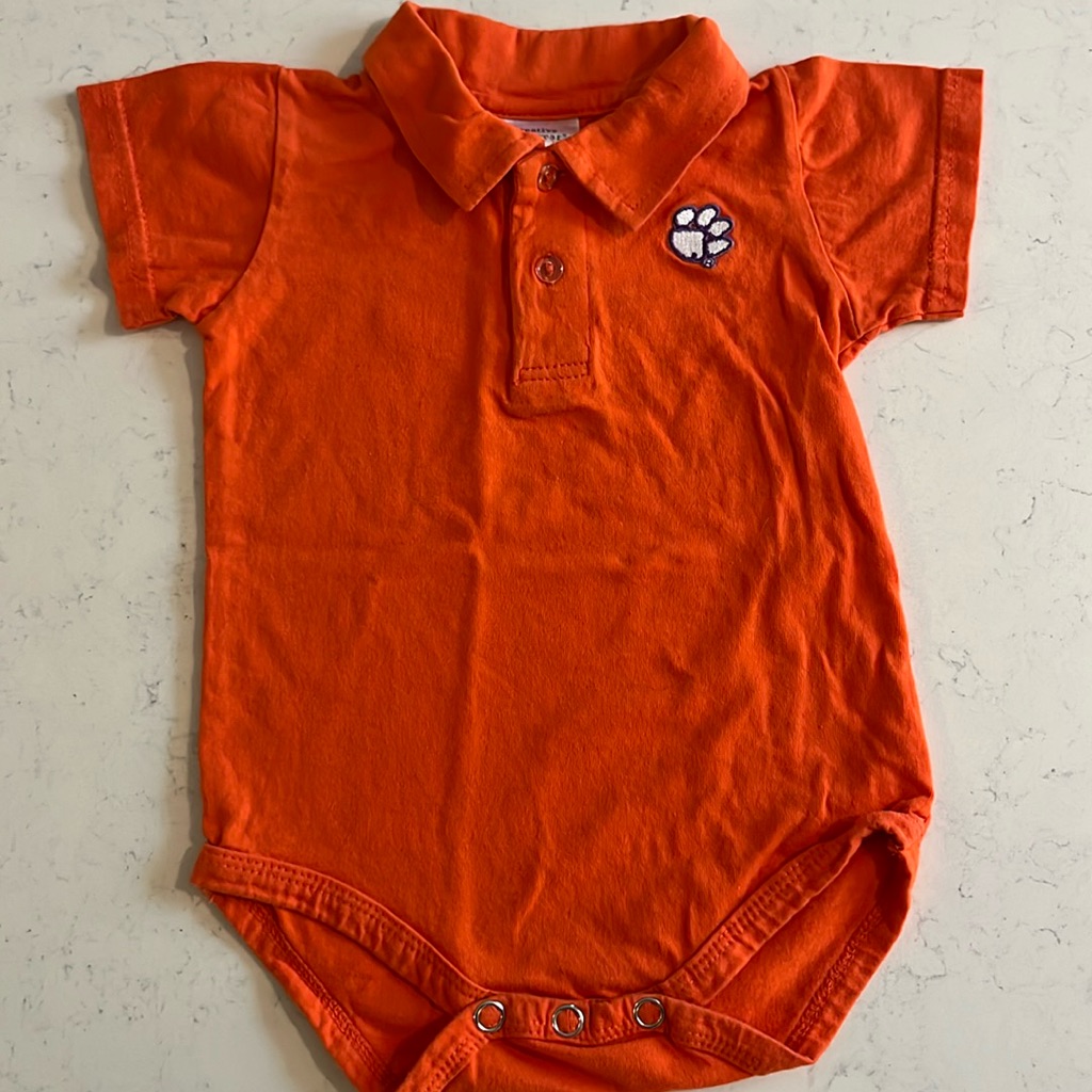 Clemson Orange Collared Onesie With Purple And White Paw Print. Size 6-9 Months